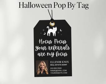 May include: A black Halloween Pop By Tag with the text "Hocus Pocus your referrals are my focus". The tag features a white cat silhouette, stars, and crescent moons. Includes a photo of a real estate agent and contact information.