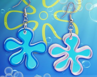 May include: A pair of blue and pink flower-shaped earrings with silver hooks. The earrings are layered and have a 3D effect.