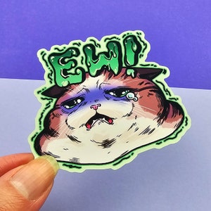 May include: A green and white sticker with the word "EWW" in dripping green letters. The sticker features a cartoon cat with a sad expression and a single tear.