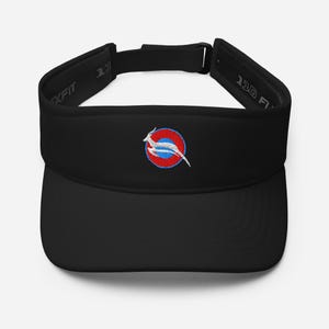 May include: Black visor with a curved brim and adjustable strap. The visor features an embroidered emblem of a white antelope leaping across a blue stripe within a red and blue circle. The text "110 Flexfit" is visible on the side.