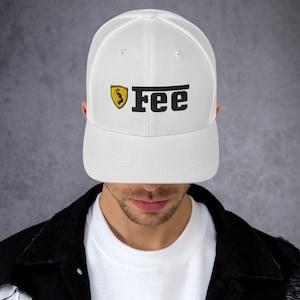 May include: White trucker hat with a black embroidered Ferrari logo and the word "Fee" in black.