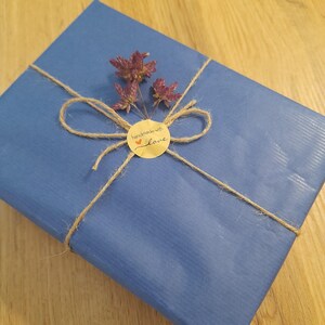 Eco-friendly baby gift packaging with cotton bee plush, sustainable wrap