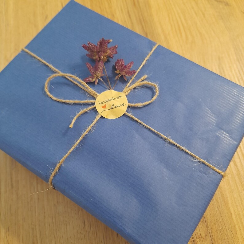 Eco-friendly baby gift packaging with cotton bee plush, sustainable wrap