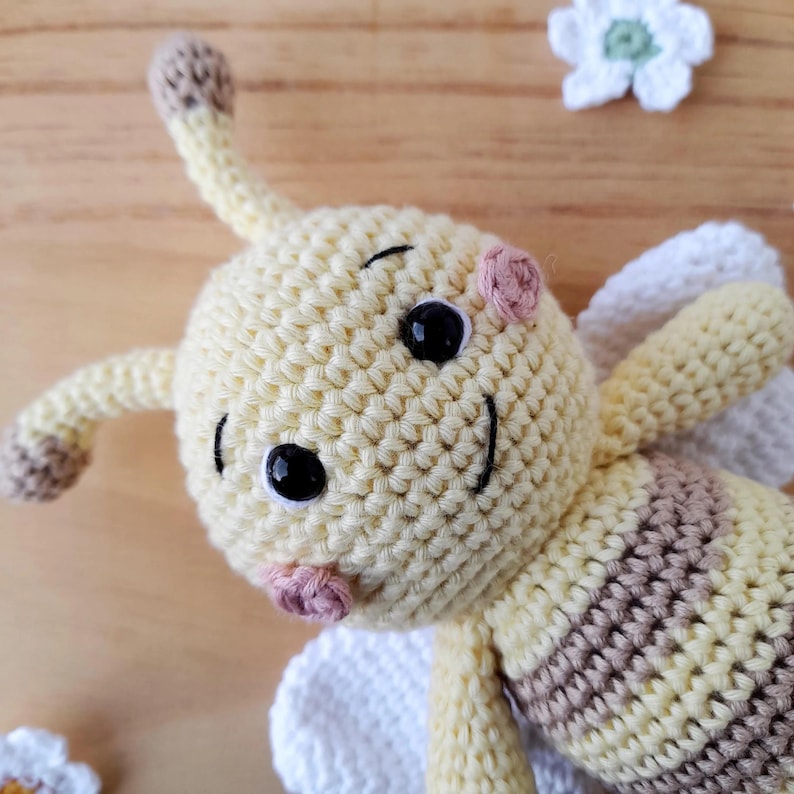Close-up cotton crochet bee face, artisan handcrafted baby plush