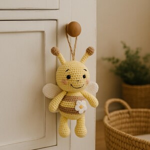 Bee plush hanging from a nursery door knob, rustic neutral décor gift handmade in organic cotton.