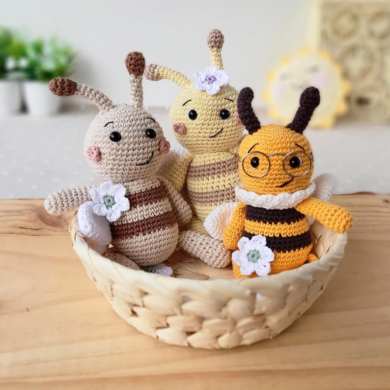 Three organic cotton bee plush toys in a basket, neutral rustic edition for eco-conscious baby gifts.