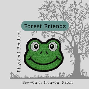 May include: A green frog patch with a black outline and white eyes. The patch is embroidered and has the text "Forest Friends" above it. The patch is a sew-on or iron-on product.