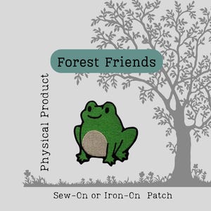 May include: A green frog patch with a tan belly, outlined in black, is featured on a light gray background. The patch is labeled "Forest Friends" and is a sew-on or iron-on patch. A tree silhouette is in the background.