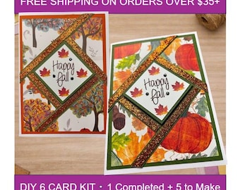 May include: Two rectangular greeting cards featuring autumn themes. Each card has a central diamond-shaped panel with the text Happy fall and maple leaf accents. The cards are decorated with orange glitter tape and illustrations of pumpkins, acorns, and trees.