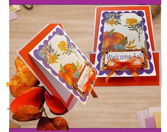 May include: A DIY 6 card kit featuring two greeting cards with a pumpkin and floral print, scalloped purple borders, orange cardstock, and a tag with the text Welcome Fall accented by an orange ribbon. The kit includes one completed card.