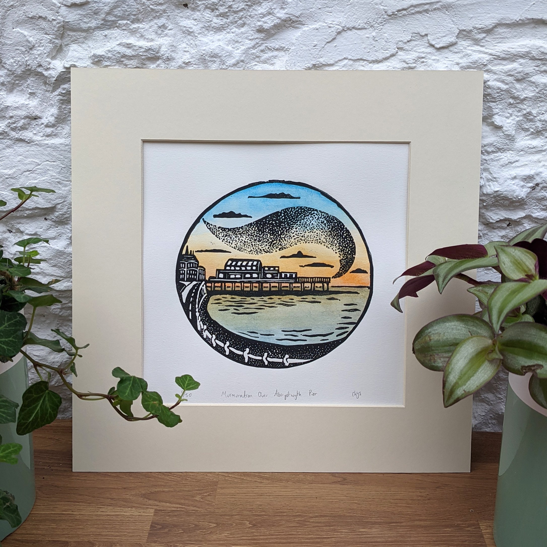 Murmuration Over Aberystwyth Pier. Original lino print and watercolour.