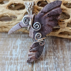 Wire wrapped hummingbird in sterling silver setting