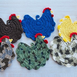 May include: Six crocheted chicken pot holders in various colors, including brown, blue, yellow, green, and gray. The pot holders are all shaped like chickens with red combs and yellow beaks.