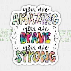 May include: A colorful sticker with the text "You are amazing, you are brave, you are strong" with floral patterns in the letters.