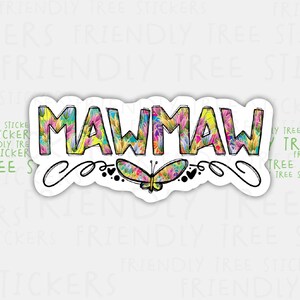 May include: A colorful sticker with the word "Mawmaw" written in a whimsical font. The letters are filled with a floral pattern and surrounded by a decorative swirl. A butterfly with colorful wings is centered below the word.