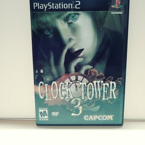 May include: PlayStation 2 video game case with a dark blue background and a woman's face in the center. The title "CLOCK TOWER 3" is in white with a clock face behind it. The game is rated "M" for Mature by the ESRB and is a DVD-ROM.