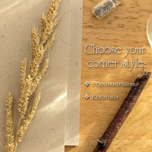 May include: A beige speckled card with a stalk of dried wheat, a small glass vial containing dried lavender, and a dark brown twig. The text reads: Choose your corner style: Standard Sharp, Rounded. The items are arranged on a light wood surface.