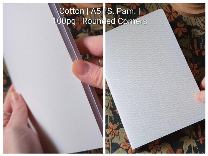 May include: A white notebook with a textured cover, featuring rounded corners and A5 size. The text on the image reads: Cotton | A5 | S. Pam. | 100pg | Rounded Corners. The notebook has 100 pages and is made of cotton material.