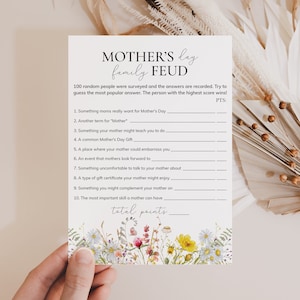 May include: A printable Mother's Day game with a floral border. The game is called "Mother's Day Family Feud" and asks players to guess the most popular answers to 10 questions about mothers. The game includes a space to record the total points.