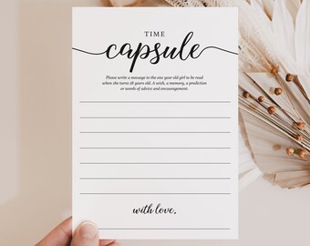 May include: A white card with black text that reads "Time Capsule". The card has lines for writing a message to a one-year-old girl to be read when she turns 18 years old. The card also has the text "with love," at the bottom.