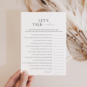 May include: A printable game card with the title "Let's Talk Numbers". The card features a list of 13 questions about numbers, such as "The number of seconds in an hour" and "The number of horns on a unicorn".