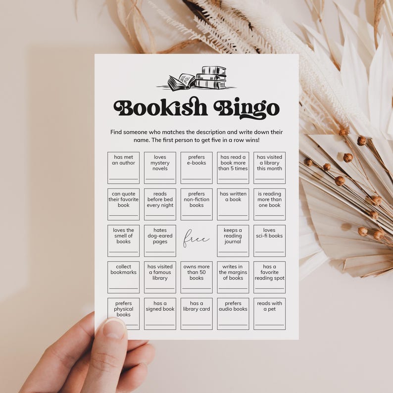 May include: A black and white printable bingo card with the title "Bookish Bingo". The card has 25 squares with different book-related activities or preferences.  The free space is in the center of the card.