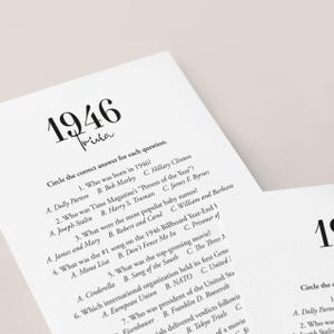 May include: White paper trivia game cards with the year 1946 in large black font. The cards feature trivia questions about the year 1946, including pop culture and historical events. The text "Trivia" is written in a cursive font.