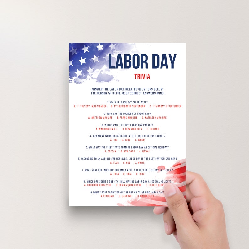 May include: A Labor Day trivia game card featuring a watercolor American flag design at the top and bottom. The text reads Labor Day Trivia followed by nine multiple-choice questions about the holiday, printed in dark blue and red on white paper.
