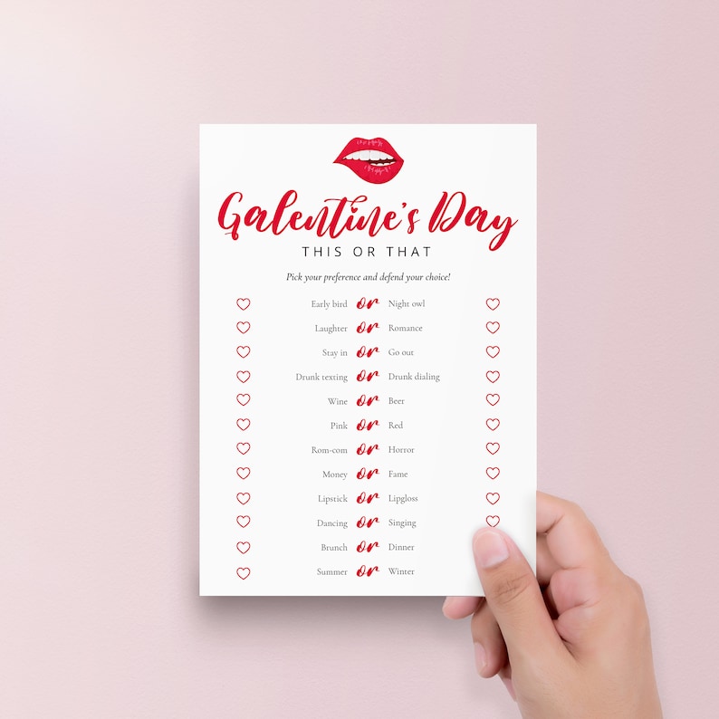 May include: A printable Galentine's Day game card with a red lipstick illustration and the text "Galentine's Day This or That". The card features a list of 12 "This or That" questions with hearts and red "or" symbols.