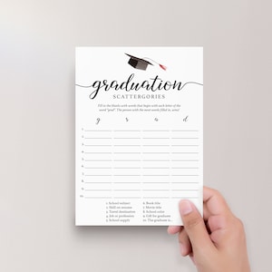 May include: A white graduation Scattergories game card with a black mortarboard illustration and the word "graduation" in elegant script. The card includes fill-in-the-blank prompts for a fun party game.