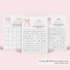May include: A set of 30 pink and white baby shower bingo cards with a pink bow on each card. The cards have a variety of baby-related items listed on them, such as diapers, bottles, and pacifiers. The text on the cards reads "Baby Bingo".