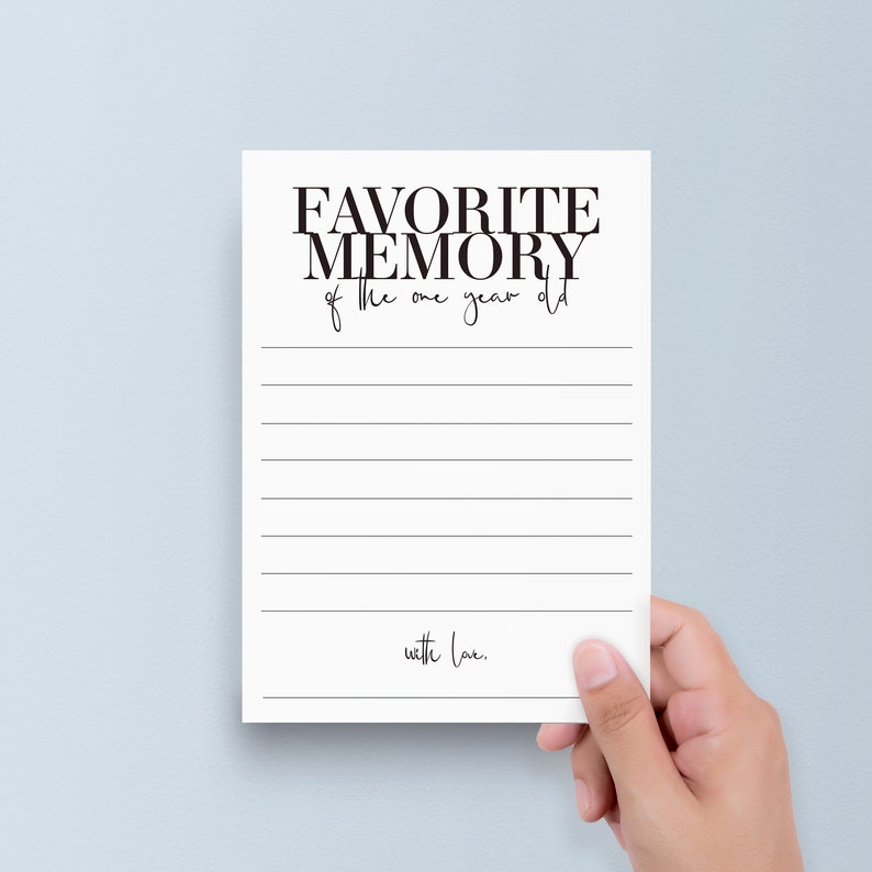May include: A white card with black text that reads "FAVORITE MEMORY of the one year old with love." The card has lines for writing.