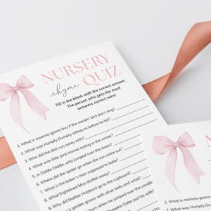 May include: A pink and white printable nursery rhyme quiz game with a pink watercolor bow on the top. The quiz asks questions about popular nursery rhymes like Humpty Dumpty, Little Jack Horner, and Miss Muffet.