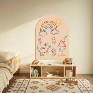 May include: An arched wall decal featuring a light peach background with colorful child-like drawings including a rainbow, a smiling sun, a green dinosaur, a house with a chimney, and various flowers, applied to a plain interior wall surface.