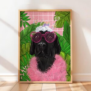 May include: Framed art print of a black dog wearing pink heart-shaped sunglasses and a pink boa. The dog is set against a pink grid background with green tropical leaves and bubbles. The artwork has a fun, whimsical style, perfect for a home.