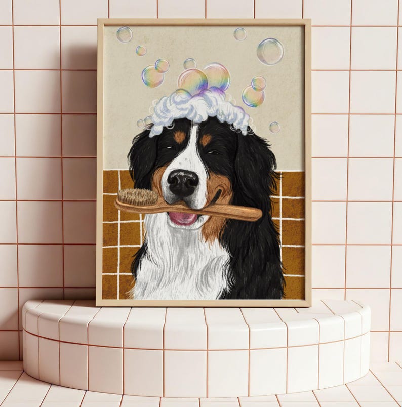 May include: A framed illustration of a Bernese Mountain Dog with a wooden brush in its mouth, covered in suds and bubbles. The dog has black, white, and brown fur. The background features a tiled wall and floating bubbles.