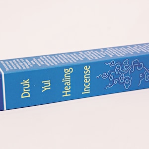 May include: A blue box of Druk Yul Healing Incense. The box features a stylized tree design and the text "Druk Yul Healing Incense".