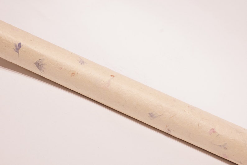 May include: A roll of beige wrapping paper with a subtle floral pattern featuring small blue and orange flowers.