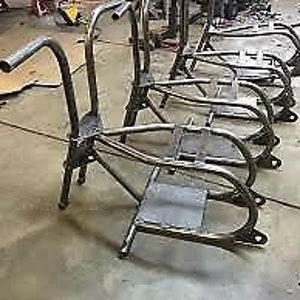 May include: Four unfinished metal frames for building a custom motorcycle. The frames are made of steel tubing and have a black powder coat finish.