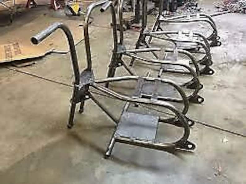 May include: Four unfinished metal frames for building a custom motorcycle. The frames are made of steel tubing and have a black powder coat finish.
