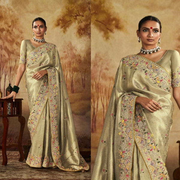 Sari di design Banarasi in tessuto morbido dorato tono verdastro con bordo ricamato.