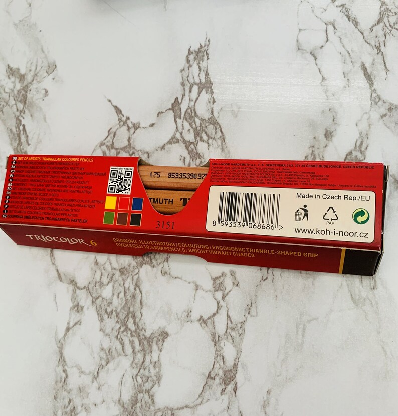 May include: A red box of Koh-I-Noor Triocolor 6 artist pencils. The box features the text "TRIOCOLOR 6" and "DRAWING/ILLUSTRATING/COLOURING/ERGONOMIC TRIANGLE-SHAPED GRIP". The pencils are oversized 0.41 inch pencils with bright, vibrant shades.