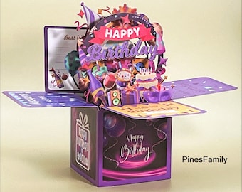 May include: Purple pop-up birthday card with a 3D scene of a birthday party with balloons, cake, and gifts. The card is open and the inside says "Happy Birthday".