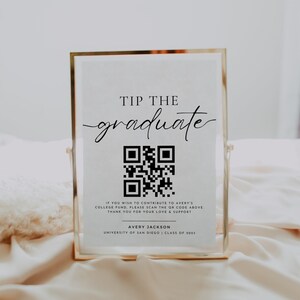 May include: A white sign with a gold frame and black text that reads "Tip the graduate". A black and white QR code is below the text. The text below the QR code reads "If you wish to contribute to Avery's college fund, please scan the QR code above. Thank you for your love & support. Avery Jackson, University of San Diego, Class of 2023."