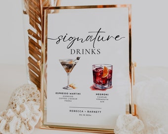 May include: A gold framed sign with the text "signature drinks" in black cursive font. The sign features two watercolor illustrations of cocktails: an espresso martini and a negroni. The text below each cocktail lists the ingredients. The sign also includes the names "Rebecca & Barnett" and the date "06.18.2024".