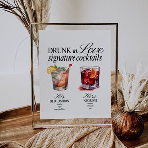 May include: A printable sign with the text "DRUNK in LOVE signature cocktails" and illustrations of two cocktails. The text below the illustrations reads "His OLD FASHION bourbon, bitters, sugar, angostura bitters" and "Hers NEGRONI Campari, vermouth, gin".