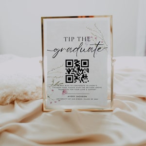 May include: A gold-framed sign with a floral design and a QR code. The sign reads "Tip the graduate" and includes the name Avery Jackson, University of San Diego, Class of 2023.
