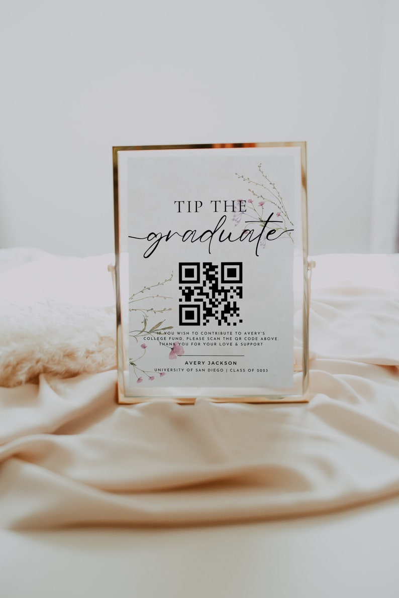 May include: A gold-framed sign with a floral design and a QR code. The sign reads "Tip the graduate" and includes the name Avery Jackson, University of San Diego, Class of 2023.