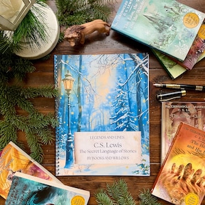 May include: A selection of books and a journal with a winter forest design. The journal cover states "LEGENDS AND LINES C.S. Lewis The Secret Language of Stories BY BOOKS AND WILLOWS." Other books include "The Lion, the Witch, and the Wardrobe" and "The Voyage of the Dawn Treader."