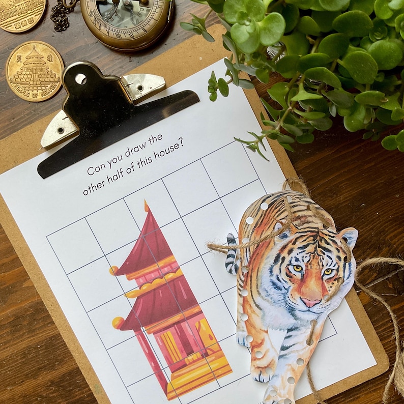 May include: A printable worksheet with a grid and a drawing of half of a Chinese-style house. The text "Can you draw the other half of this house?" is at the top of the page. A tiger illustration is on the right side of the page.